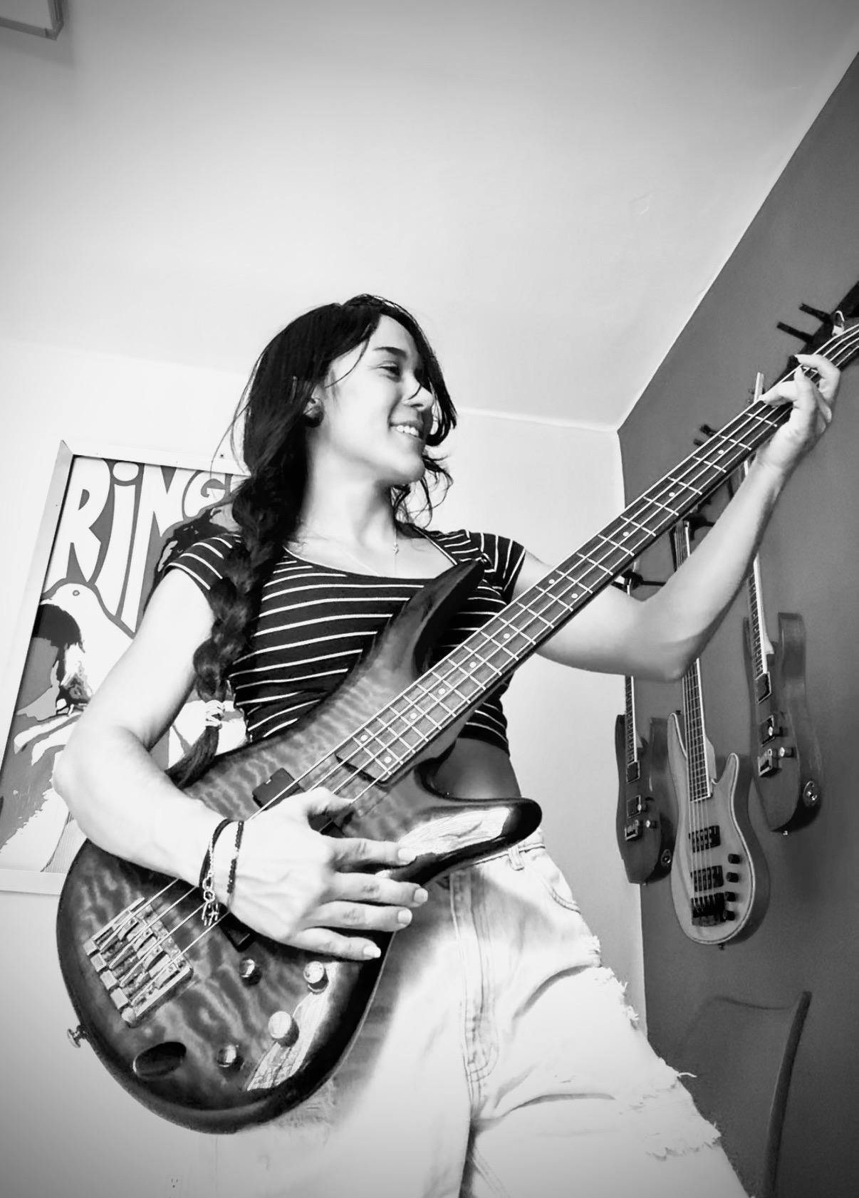 Black and white photograph of Gabie playing bass